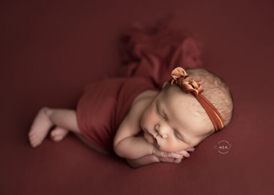 michigan newborn photographer melissa anne photography baby girl with rust bow