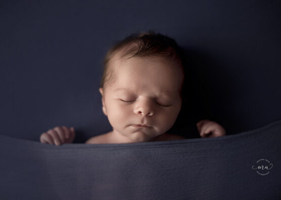 Metro Detroit Michigan newborn photographer Melissa Anne Photography tucked in pose blue
