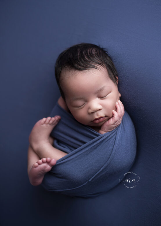 Michigan newborn photographer Melissa Anne Photography baby boy Huck Finn pose dark blue