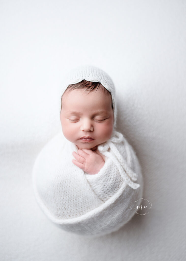 Michigan newborn photographer Melissa Anne Photography potato sack with bonnet on white