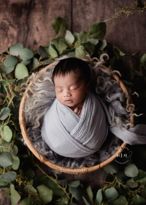 Michigan newborn photographer Melissa Anne Photography baby boy wrapped in boho basket