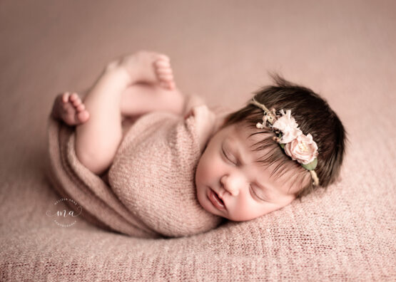 Michigan newborn photographer Melissa Anne Photography Huck Finn pose pink wrap baby girl with headband and dark hair