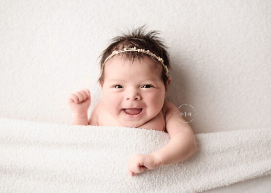Michigan newborn photographer Melissa Anne Photography smiling baby mug shot photo