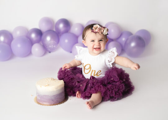 Michigan cake smash photographer Melissa Anne Photography smiling baby destroying cake