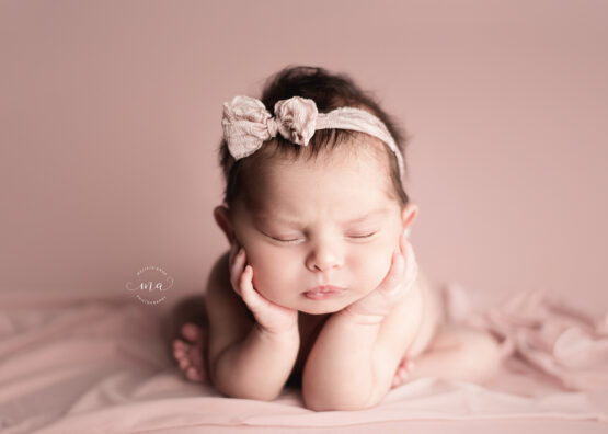 Michigan newborn photographer Melissa Anne Photography froggy pose with baby girl pink bow