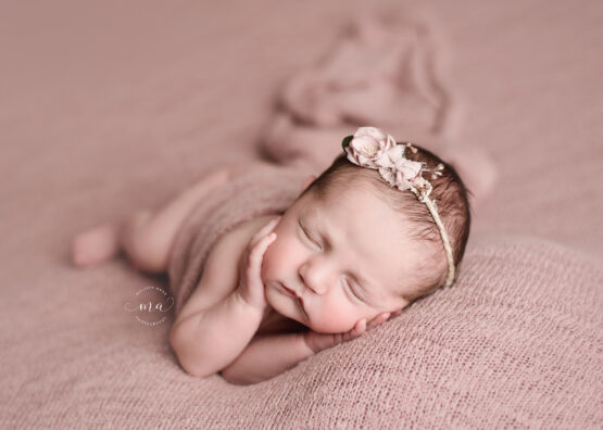 Michigan newborn photographer Melissa Anne Photography sidelay pose pink background baby girl