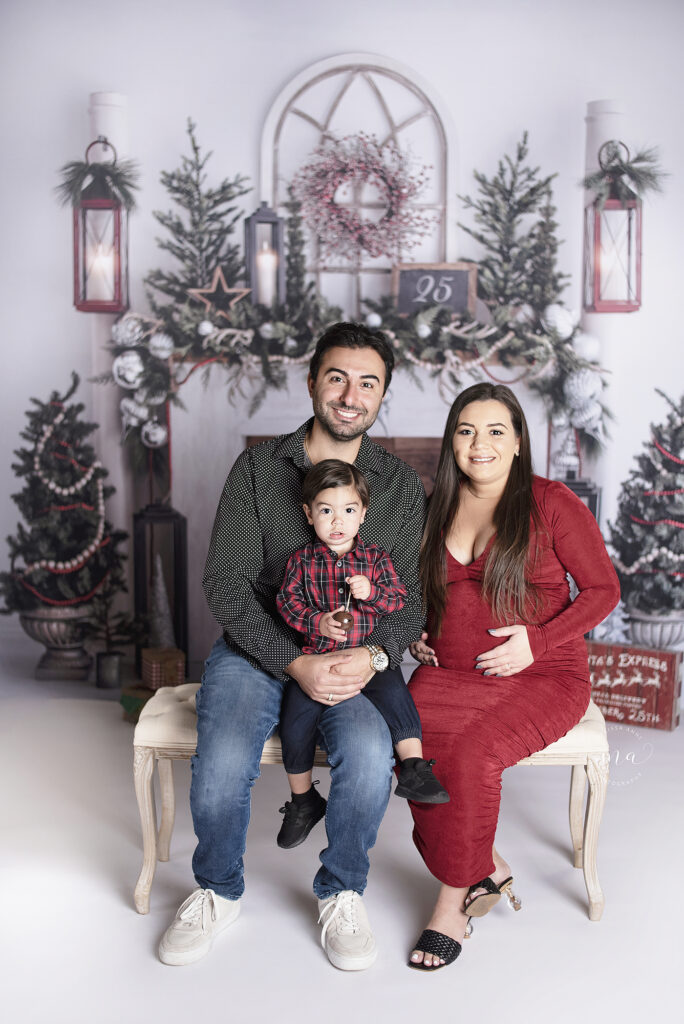 Troy Michigan photographer Melissa Anne Photography Christmas mini session white fireplace background family of three