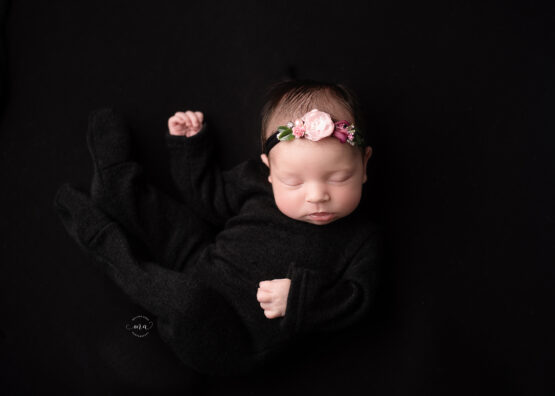 Troy Michigan newborn photographer Melissa Anne Photography baby girl black pajamas black backdrop with headband