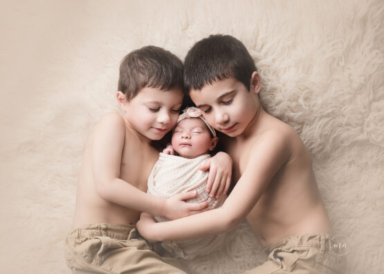 Troy Michigan newborn photographer Melissa Anne Photography big brothers with newborn sister on flokati