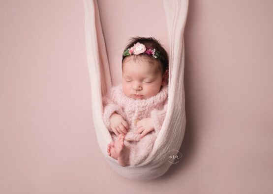Troy Michigan newborn photographer Melissa Anne Photography pink knit pajamas baby girl swing pose