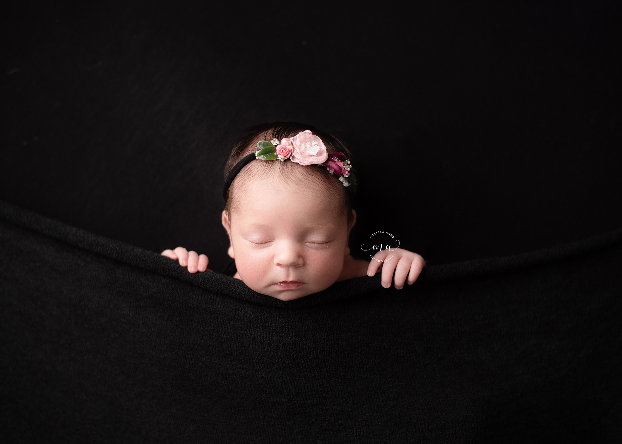 troy michigan newborn photography melissa anne photography baby girl tucked in pose with black background
