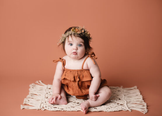Troy Michigan photographer Melissa Anne photography sitter milestone session with girl with flower crown rust background