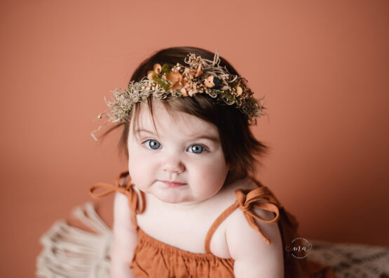 Troy Michigan photographer Melissa Anne photography boho floral crown rust romper milestone sitter photo session