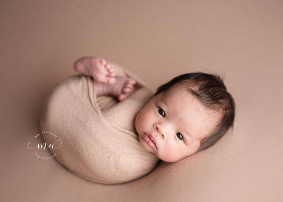 Michigan newborn photographer Melissa Anne Photography baby boy with lots of hair with eyes open