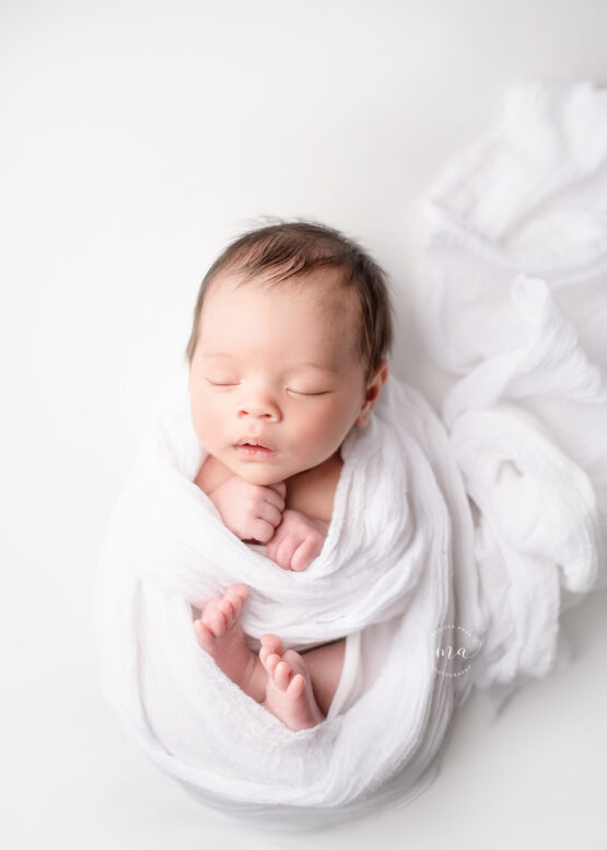 Michigan newborn photographer Melissa Anne Photography baby boy wrapped in white flowy wrap