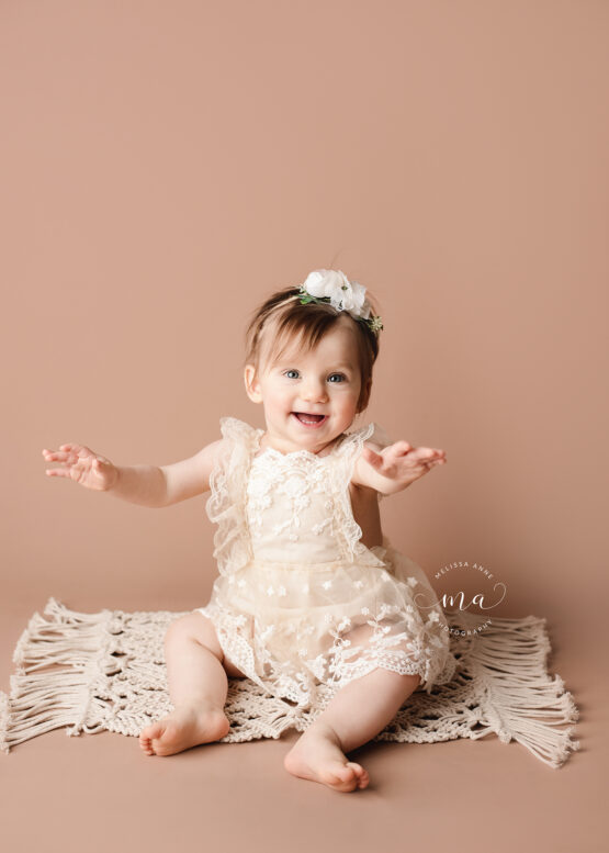 Michigan photographer Melissa Anne Photography one year portrait session with adorable girl neutral romper and headband