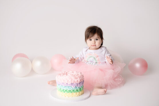Troy Michigan photographer Melissa Anne Photography pastel rainbow cake smash milestone first birthday little girl with dark hair