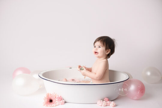 Troy Michigan photographer Melissa Anne Photography pastel rainbow cake smash washtub photo session with cute girl