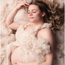 Metro-Detroit-Maternity-Photographer-Melissa-Anne_Photography-pregnant-mother-in-neutral-tulle-couture-gown-laying-down-with-eyes-closed-and-hair-flowing