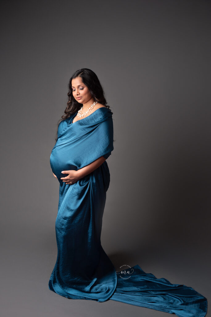Metro Detroit Michigan maternity photographer Melissa Anne Photography dark blue scarf wrapped around pregnant mother to be in studio maternity photo session