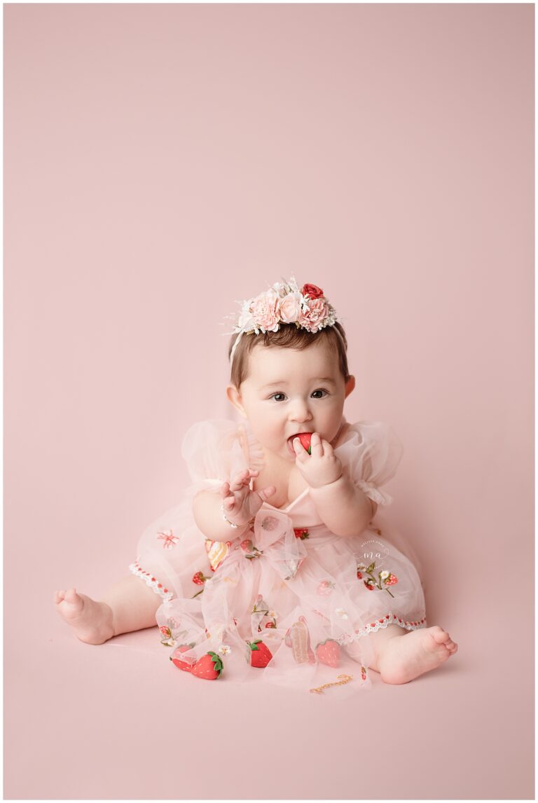 Metro Detroit photographer Melissa Anne Photography six month old girl with strawberries in pin dress