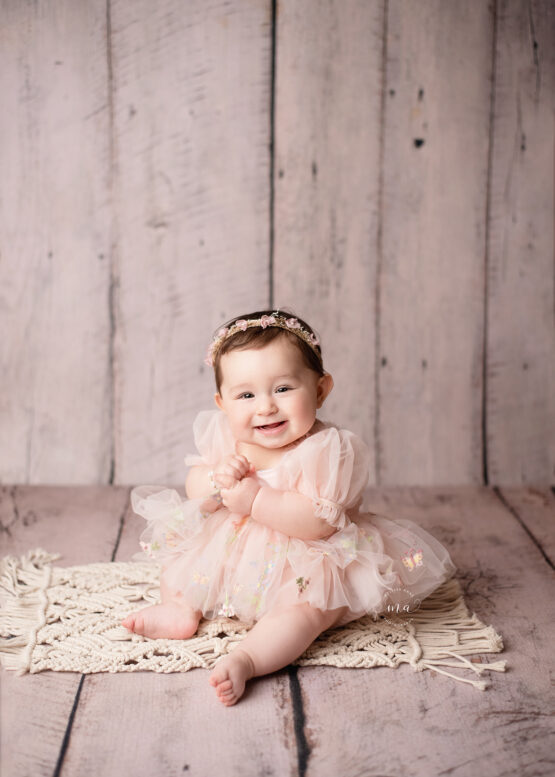 metro Detroit photographer Melissa Anne Photography sitter photo session with little girl in pink tulle dress smiling