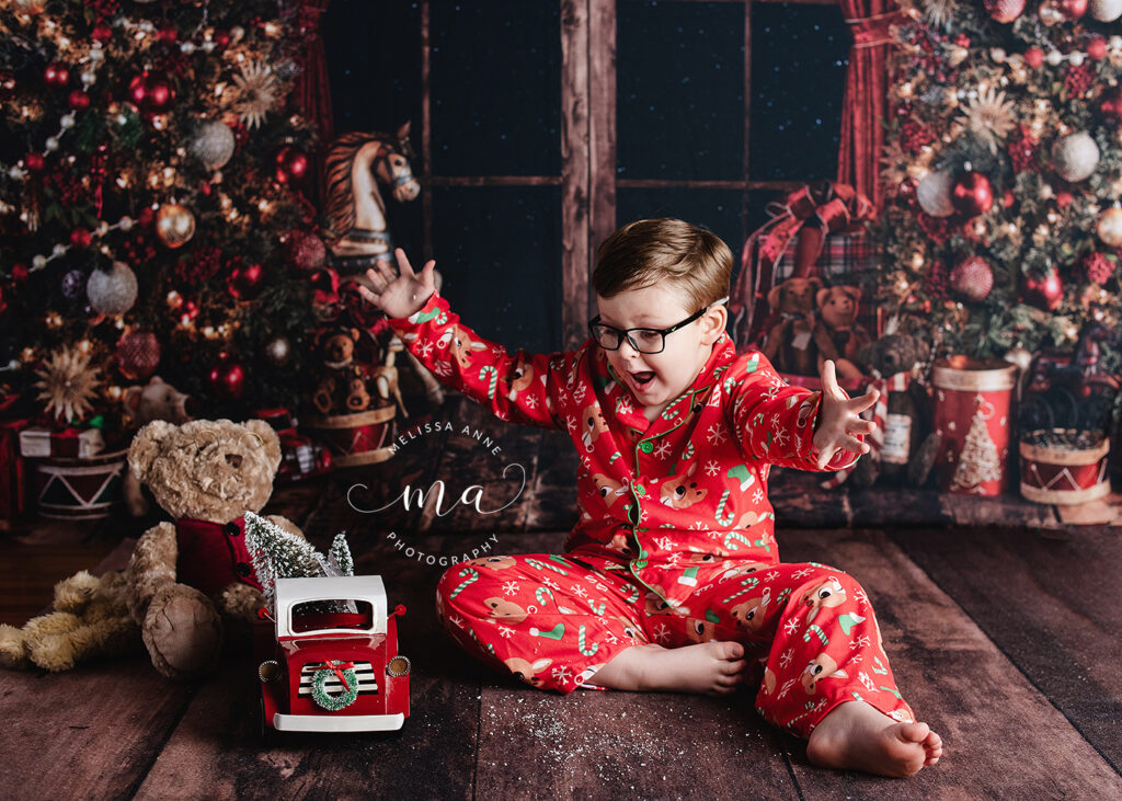 Michigan photographer Melissa Anne Photography little boy in pajamas playing with snow