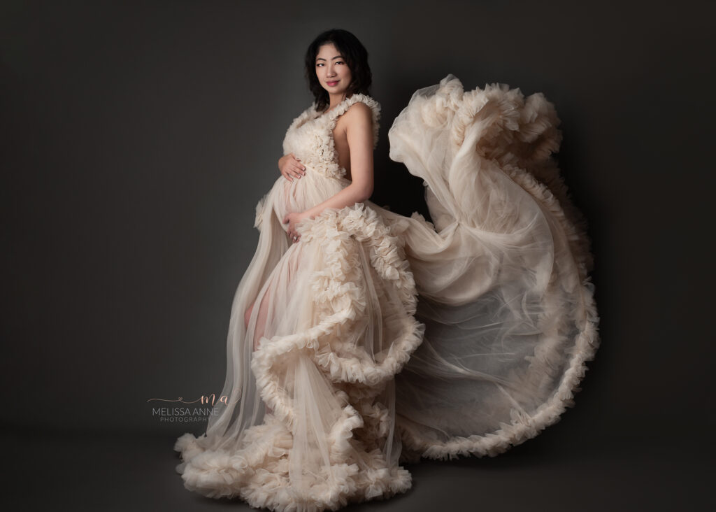 Troy Michigan maternity photographer Melissa Anne Photography luxury maternity photo session in studio with mother to be wearing custom made tulle ball gown