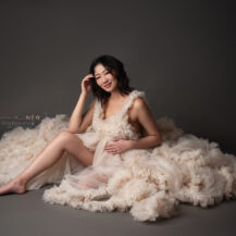 Troy Michigan maternity photographer Melissa Anne Photography luxury maternity photo session in studio with mother to be wearing custom made tulle ball gown relaxed pose