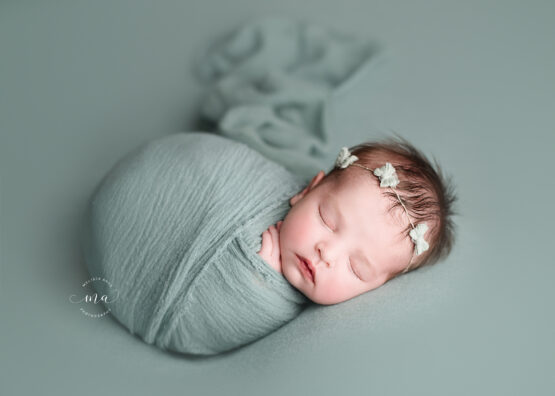 Troy Michigan newborn photographer Melissa Anne Photography baby girl sage green headband and wrap fallen potato sack pose