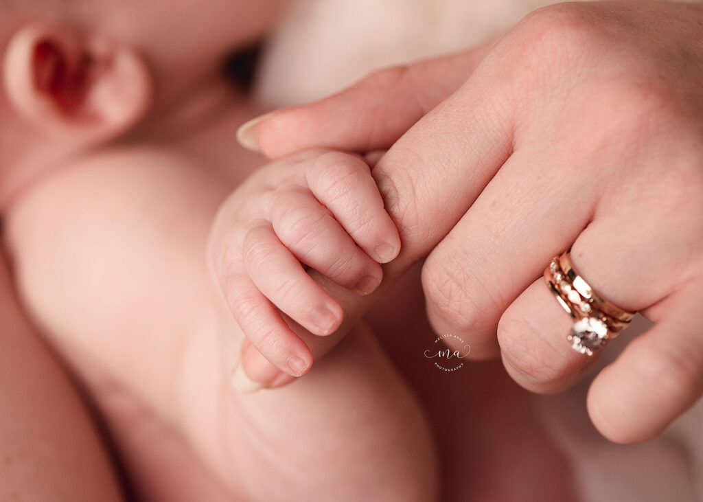 Troy Michigan photographer mother holding baby hand Melissa Anne Photography