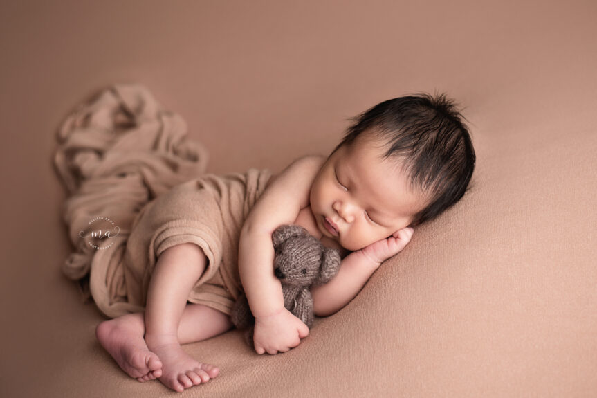 Troy Michigan newborn photographer Melissa Anne Photography side lay pose with flowy neutral wrap baby boy