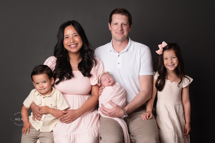 Royal Oak Michigan newborn photographer Melissa Anne Photography newborn baby girl with family on dark gray background