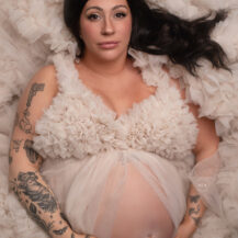Troy Michigan maternity newborn photographer Melissa Anne Photography laying down in cream tulle gown