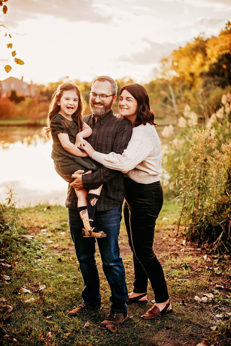 Troy Michigan family photographer Melissa Anne Photography mom dad and daughter snuggling in park