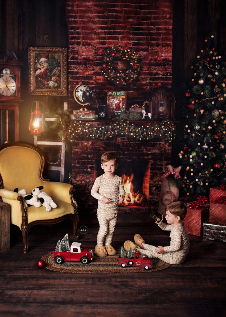 Troy Michigan Christmas mini sessions Melissa Anne Photography twin boys in pajamas playing with vintage toys in front of fireplace