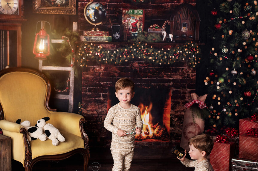Troy-Michigan-Christmas-mini-sessions-Melissa-Anne-Photography-twin-boys-in-pajamas-playing-with-vintage-toys-in-front-of-fireplace